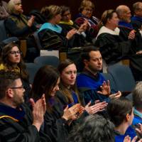 Crowd applauding one another